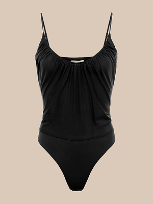 The Gelina Mesh Bodysuit, a black one-piece with adjustable straps, a gathered scoop neckline, and high-cut leg openings, is shown against a plain beige background.