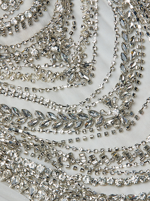 Close-up of the Yun Draped Crystal Tank, featuring sparkling rhinestones in intricate patterns arranged in circular rows—a stunning statement piece perfect for elevating your holiday party outfit.