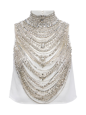 The Yun Draped Crystal Tank is a sleeveless white top featuring elaborate silver and crystal embellishments across the chest and high neckline—an ideal statement piece for any holiday party look.