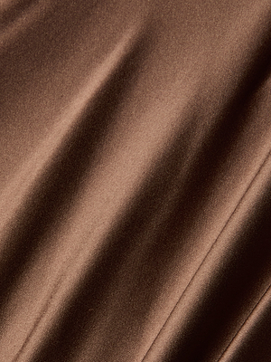 Close-up of the Calista Silk Camisole in smooth, shiny brown bias-cut silk, featuring gentle folds and diagonal shadows that highlight its luxurious silky texture.