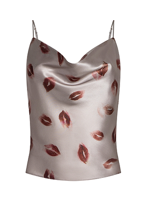 The Calista Satin Camisole is a silky silver top with adjustable straps, a draped neckline, and a playful pattern of red lipstick kiss marks scattered across the fabric.