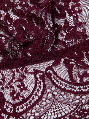 Close-up of the Aislin Lace Bralette by L'AGENCE, crafted from deep maroon Chantilly lace with intricate geometric patterns, fine netted mesh, and detailed embroidery on an unlined base.