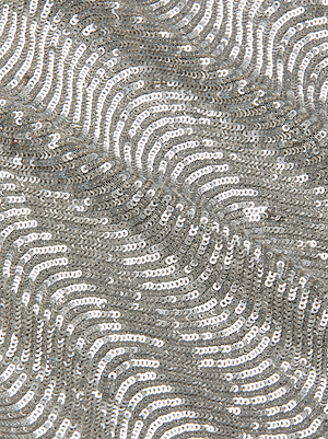 Close-up of swirling silver sequins on fabric creates a shimmering, textured surface—perfect for the Rogan Sequin Cropped Top by L'AGENCE.