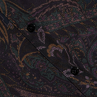 Close-up of the Ellery Button-Down Shirt made from a dark, patterned lightweight twill fabric featuring a muted paisley print and two black buttons sewn along a diagonal seam.