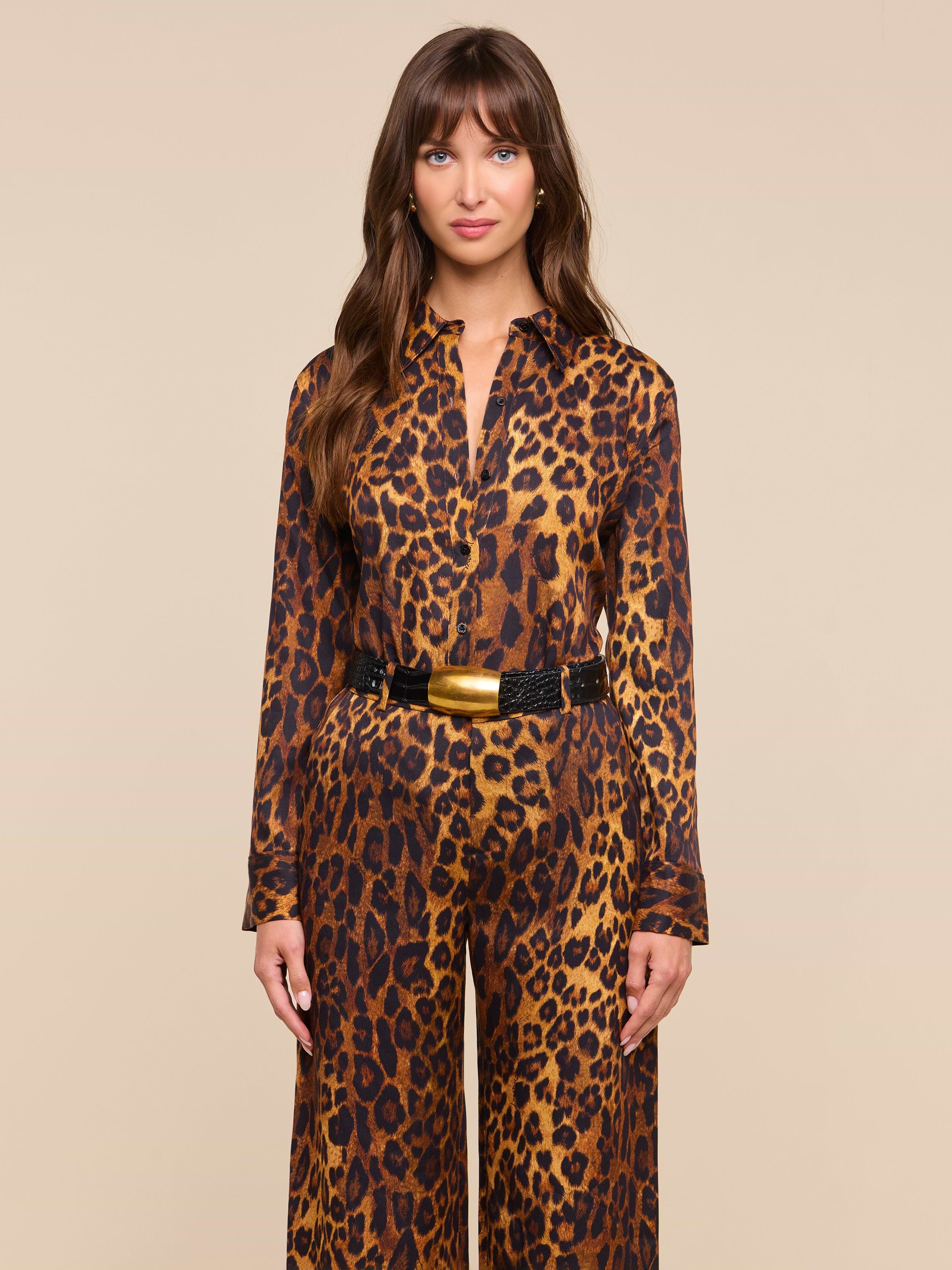 Woman with long brown hair wearing the Ellery Blouse and a black belt with a gold buckle, standing against a plain white background. The relaxed fit of the blouse highlights the effortless style of this look.