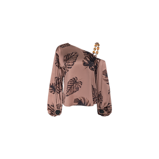 The Asami Chain One-Shoulder Blouse is a pink satin long-sleeve top adorned with black leaf prints, designed with an asymmetrical neckline and a single beaded shoulder strap.