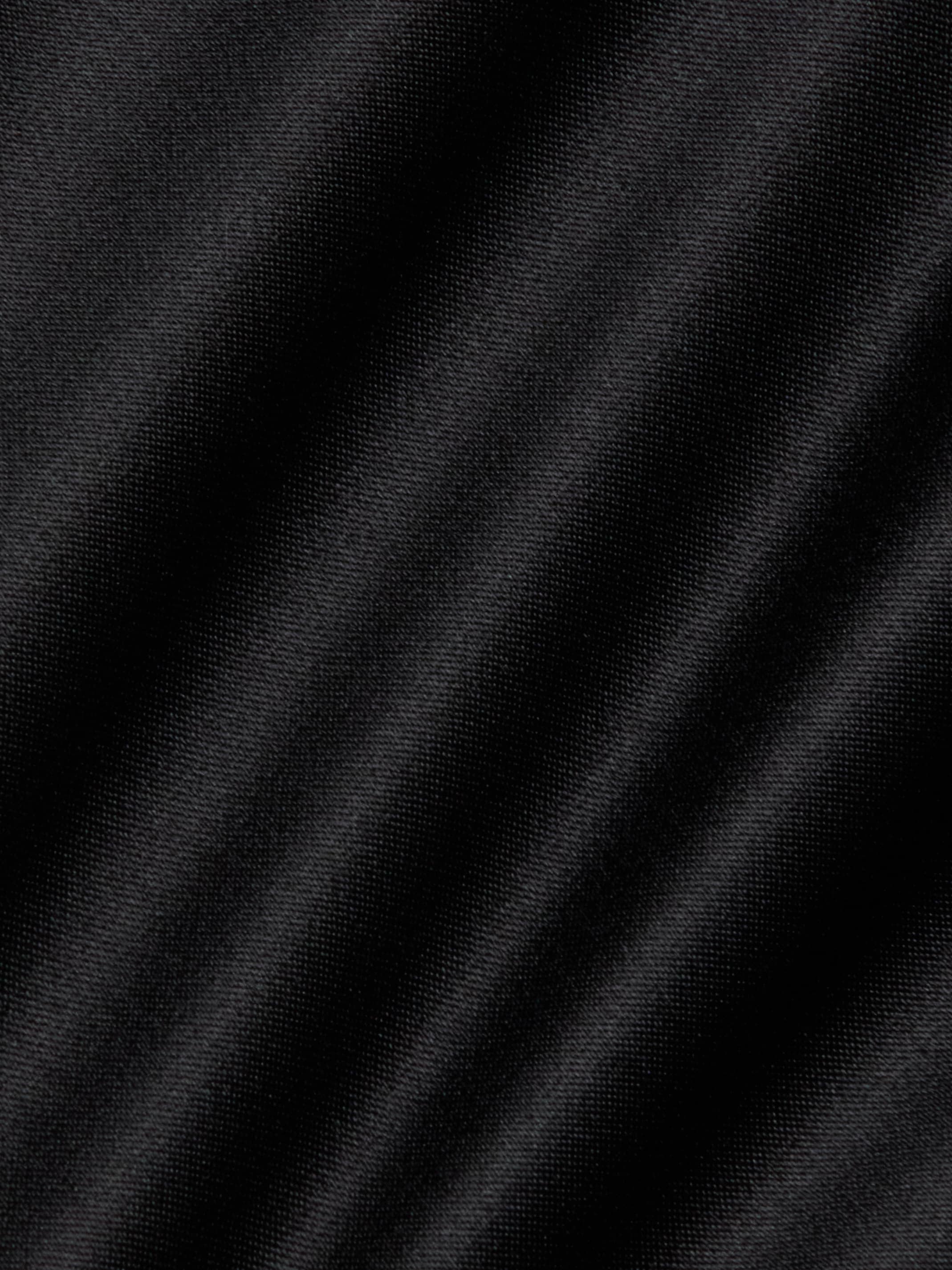 Close-up of the Dara Stretch-Satin Bodysuit showcases its black satin finish with a subtle diagonal weave pattern and soft, gentle folds that create varying shades of black and gray, enhanced by delicate adjustable straps.