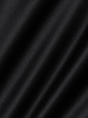 Close-up of black stretch-satin fabric with a diagonal ribbed texture and subtle sheen, highlighting the fine woven details of the L'AGENCE Dara Stretch-Satin Bodysuit with adjustable straps.