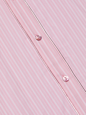Close-up of the Cosette Shirt in pink, featuring thin white vertical stripes and two pink buttons on a folded placket.