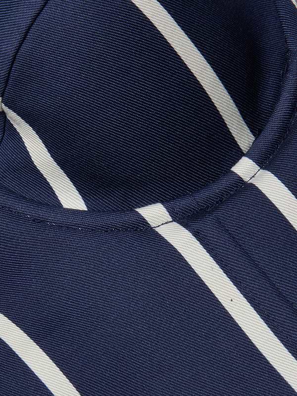 Close-up of the Sonya Bustier in navy, featuring white diagonal stripes and visible stitching, likely part of a garment or piece of clothing.