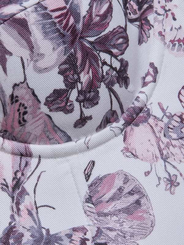 Close-up of the Sonya Bustier featuring a butterfly print and floral details in pink, purple, and white. Curved seams and stitching highlight its padded underwire cups, emphasizing the textured pattern.