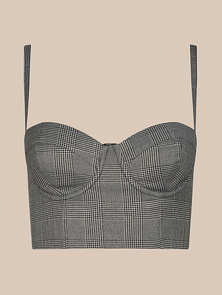 The Sonya Bustier is a gray plaid crop top featuring thin adjustable straps, structured underwire cups, and a fitted silhouette, displayed on a solid beige background.