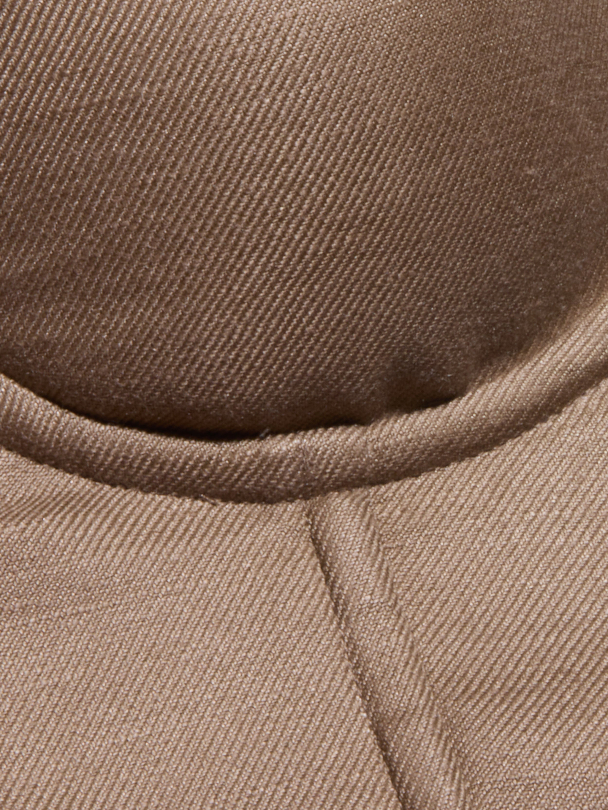 Close-up of the brown, textured fabric of the Sonya Linen-Blend Bustier, showcasing visible stitching and a curved seam.