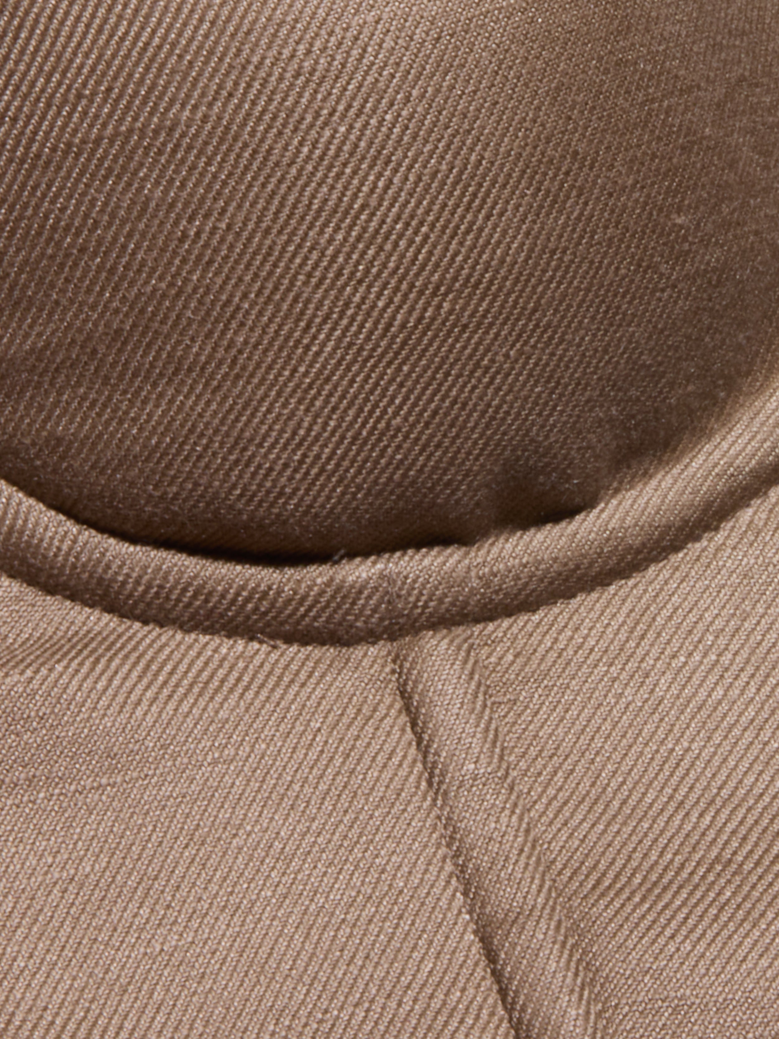 Close-up of the brown, textured fabric of the Sonya Linen-Blend Bustier, showcasing visible stitching and a curved seam.