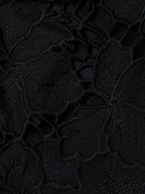 Close-up of black fabric with intricate floral embroidery, ideal for the Sonya Eyelet Bustier by L'AGENCE Sale—featuring large floral patterns and delicate stitching for a stunning, structured look.