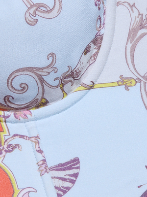 A close-up of the Sonya Bustier’s lightweight twill fabric, detailed with an ornate baroque toile print in pastel blue, purple, yellow, and orange swirls and abstract shapes.