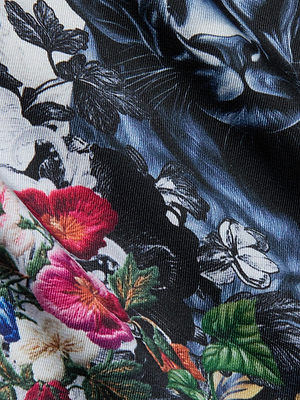 Close-up of the Fawn Panther Print Shirt, featuring a colorful floral panther design with red, pink, white, and green flowers and leaves on a dark, textured background.