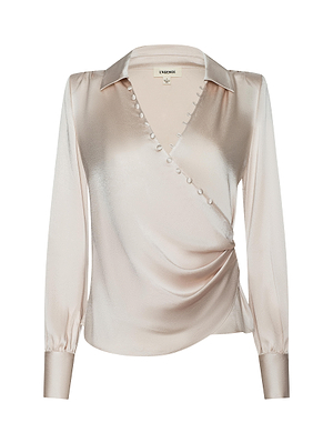 The Bernice Satin Wrap Blouse by L'AGENCE features silky champagne satin, long sleeves, a wrap-style front, decorative neckline buttons, a collar, and fitted cuffs—ideal for bringing romantic elegance to any outfit.
