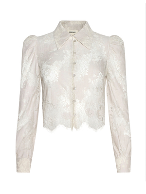 The Anita Lace Blouse features sheer ivory floral lace, long sleeves, a collared neckline, button-down front, and slight puff shoulders. Its scalloped hem and delicate semi-transparent fabric add an elegant touch to this cropped design.