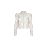 Introducing the Anita Lace Blouse: a sheer white floral lace blouse featuring long sleeves, a pointed collar, and front button closures. This cropped design showcases a slightly scalloped hem and is crafted from delicate, semi-transparent fabric.