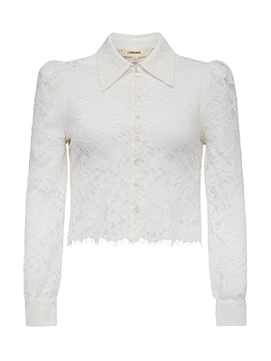 The Anita Lace Blouse is a white, long-sleeved floral lace top featuring a collar, front buttons, puffed shoulders, and a subtly frayed hem for romantic charm.