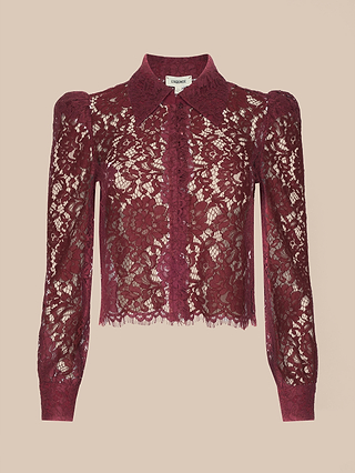 Introducing the Anita Lace Blouse: a sheer burgundy floral lace blouse featuring long sleeves, a collared neckline, and a button-down front. This romantic piece offers an elegant, semi-transparent look, with intricate floral lace detailing throughout the entire design.