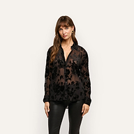 A black Laurent Velvet Blouse in crinkle velvet with a floral burnout pattern and relaxed fit, worn over a camisole.
