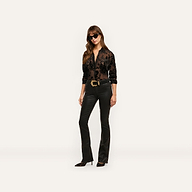 A person wears a black, sheer devoré velvet Laurent Velvet Blouse, black slim-fit trousers with a wide gold belt buckle, dark sunglasses, and pointed-toe heels.