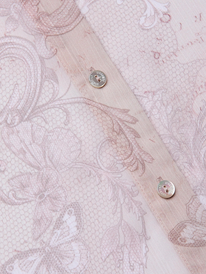 Close-up of the Laurent Blouse: sheer poly chiffon with a delicate floral and butterfly print, small hexagonal mesh, and two silver buttons along the seam—ideal for a relaxed-fit long sleeve or lace print button-down style.