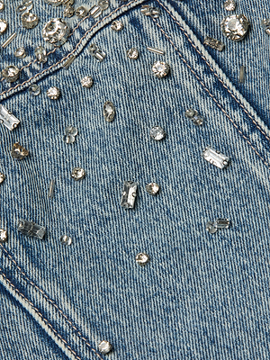 Close-up of blue denim fabric with embedded rhinestones
