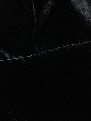 Close-up of the Aislin Velvet Bralette by L'AGENCE, showcasing its luxurious black velvet, soft smooth texture, and subtle sheen highlighted by gentle folds and light reflections.