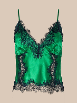 The Kimber Silk Lace Camisole, featuring green satin, thin straps, a deep V-neckline, and black lace trim on the neckline, hem, and sides, is shown against a plain beige background.