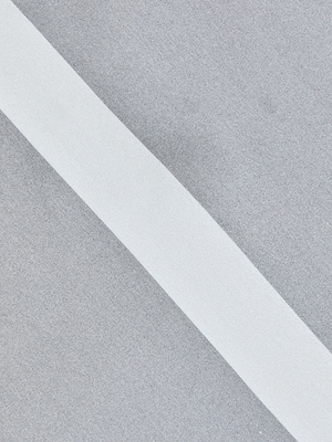 A diagonal white stripe accents the smooth, light grey surface of the Dru Silk Blouse, evoking elegant simplicity with its kimono sleeves and refined geometric pattern.