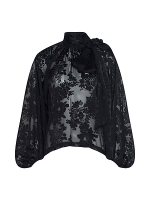 The Rhett Burnout Satin Blouse by L'AGENCE features sheer black floral-patterned satin, a loose fit, long sleeves, a high neckline, and a statement bow tie at the neck.