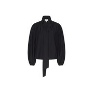 The Deon Tie-Neck Blouse is an oversized piece crafted from black organic cotton poplin, showcasing a high neck with an extended tie detail at the front, gathered shoulders, and blouson sleeves with loose cuffs, presented against a plain white background.