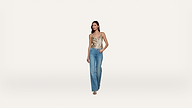 A woman wearing a gold satin camisole and blue jeans stands against a plain white background, with one hand in her pocket and the other by her side.