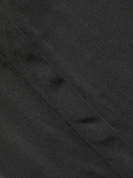 Close-up of the Honey Silk Blouse in black, showcasing a diagonal seam and subtle textured finish.