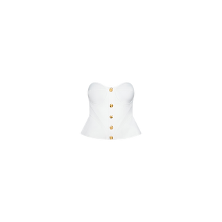 Presenting the Anna Corset Top: a strapless white bustier peplum top adorned with gold buttons down the front and expertly fitted at the waist to create a sculptural silhouette. The product is photographed against a plain white background.