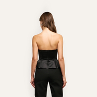 Back view of a person wearing a black strapless Meliora Corset Peplum Top with matching trousers.