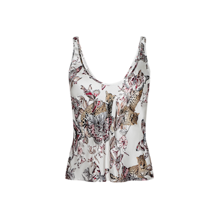 The Eddie Tank is a sleeveless white blouse with a scoop neckline, showcasing a vibrant print of leopards and butterflies among pink floral accents on a plain background.