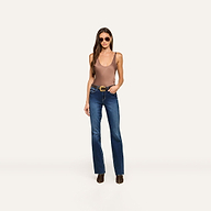 A woman wearing sunglasses, the Eddie Tank—a bias-cut satin tank top in cardamom brown with a scoop neckline—blue jeans, and brown ankle boots stands facing forward against a plain white background.