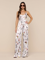 A woman wearing the Charmy Satin Camisole and sunglasses stands confidently against a plain white background.