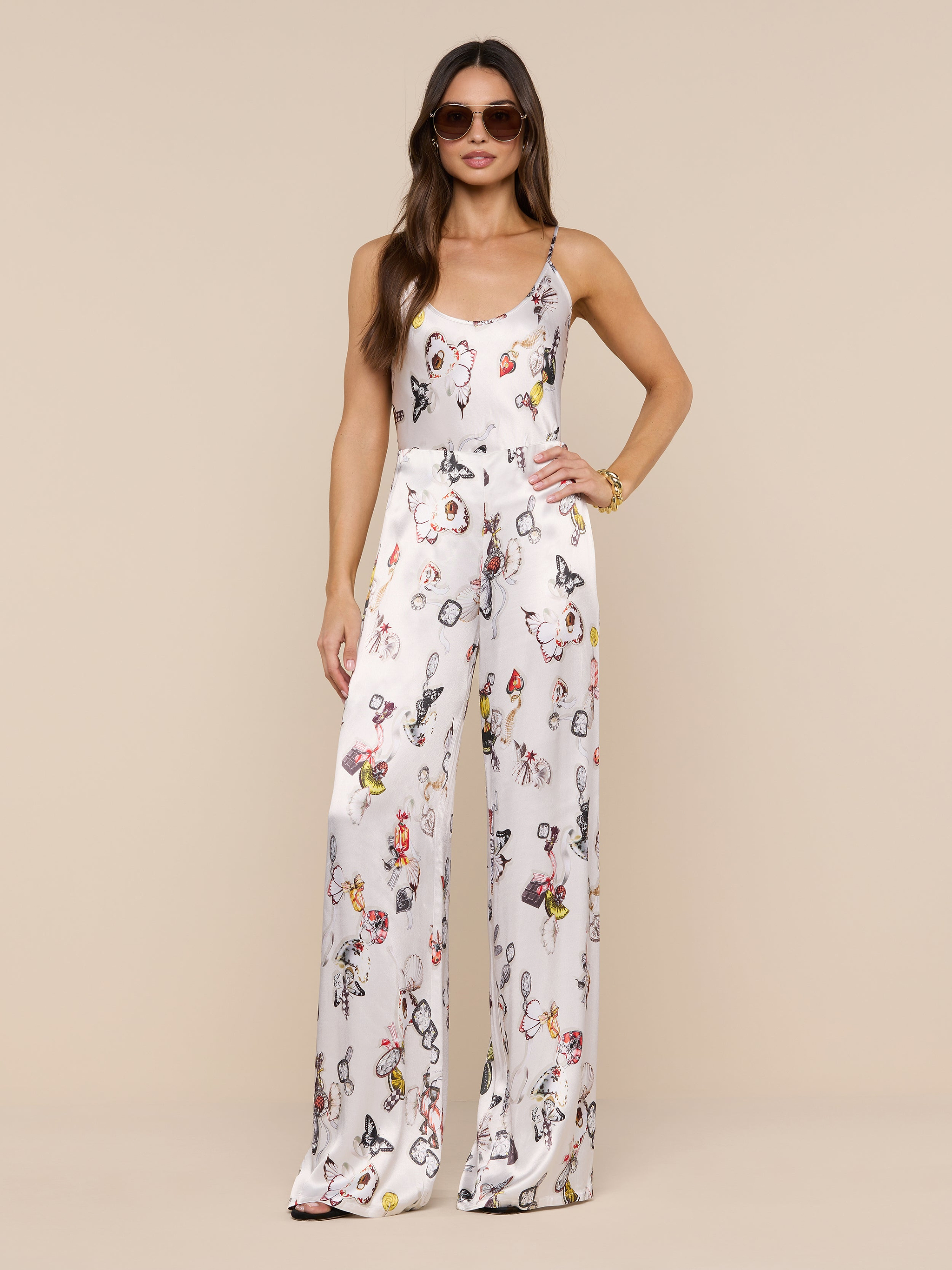 A woman wearing the Charmy Satin Camisole and sunglasses stands confidently against a plain white background.