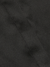 Close-up of the Phoebe Silk Blouse in black silk charmeuse, featuring a visible diagonal seam through the center that highlights the fabric’s texture and intricate stitching detail.