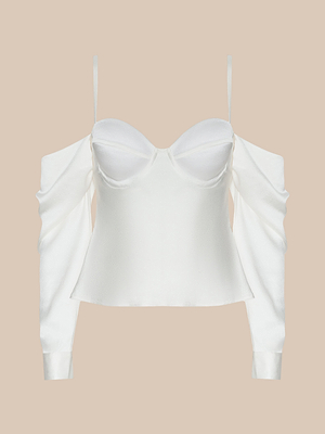 The Saya Satin Top is a white satin off-the-shoulder design with thin spaghetti straps, underwire cups, long draped sleeves, and a fitted bodice, shown elegantly against a neutral beige background.