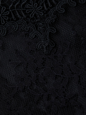 Close-up of the Kaelith Lace Bodysuit highlights its intricate Chantilly floral lace, geometric patterns, delicate embroidery, and fine texture.