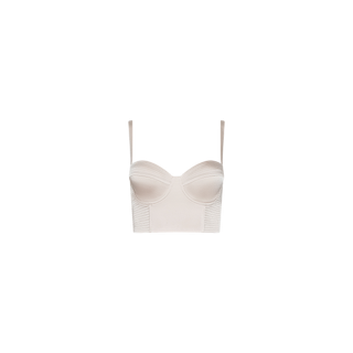 The Nysa Bustier Top is a light beige piece featuring thin straps, structured satin cups, and ribbed panel detailing at the sides, shown against a plain white background.