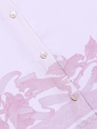 Close-up of the Judy Blouse, a light pink button-down shirt featuring two white buttons and a subtle leopard print and floral pattern in a slightly darker pink shade.