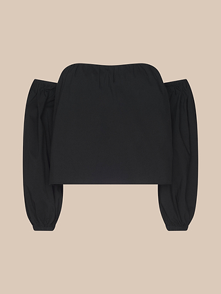 The Sarai Off-The-Shoulder Top is a black, organic cotton piece featuring long, puffy sleeves and a straight neckline, shown against a beige background.