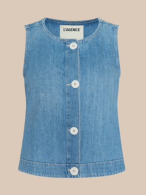 Sleeveless light blue denim vest with large white buttons down the front and a round neckline, displayed on a plain beige background. The label “L’AGENCE” is visible inside the collar.
